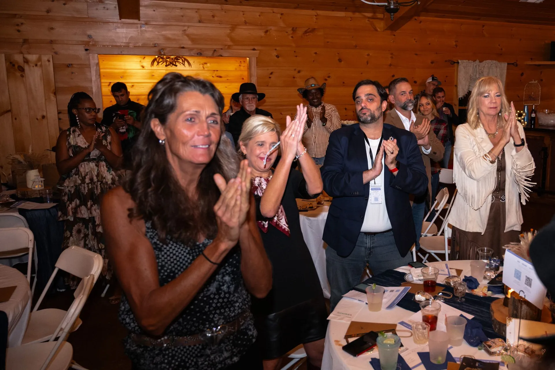 Guests applauding together during the Blue Jean Ball