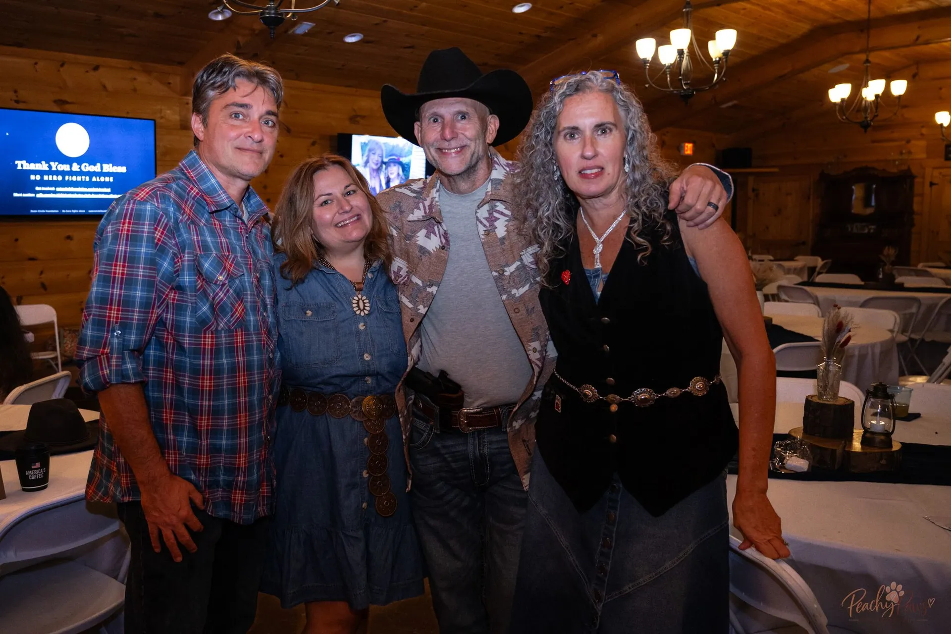 Blue Jean Ball supporters smiling together beneath the No Hero Fights Alone message
