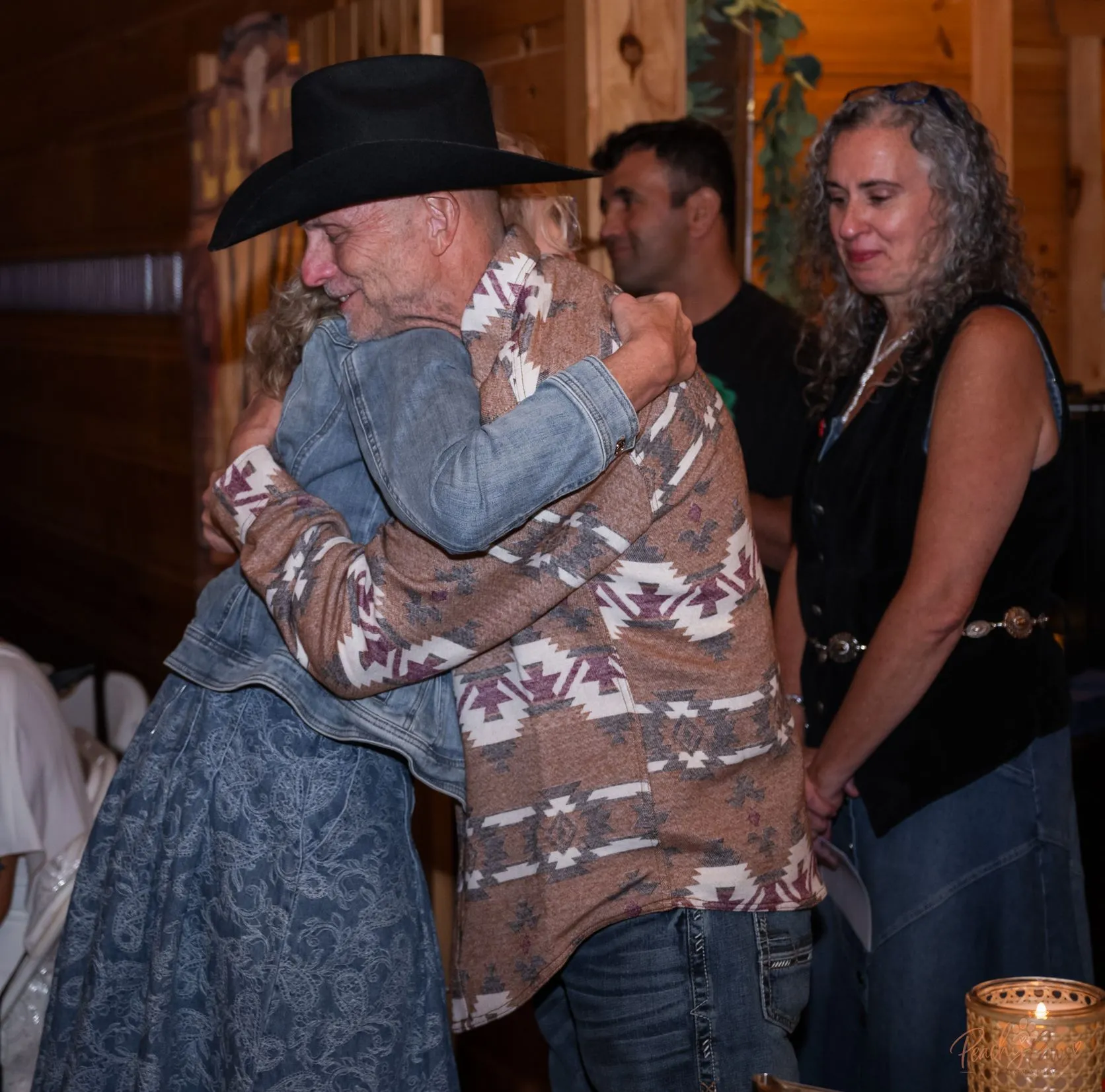 Two guests embracing warmly at the Blue Jean Ball