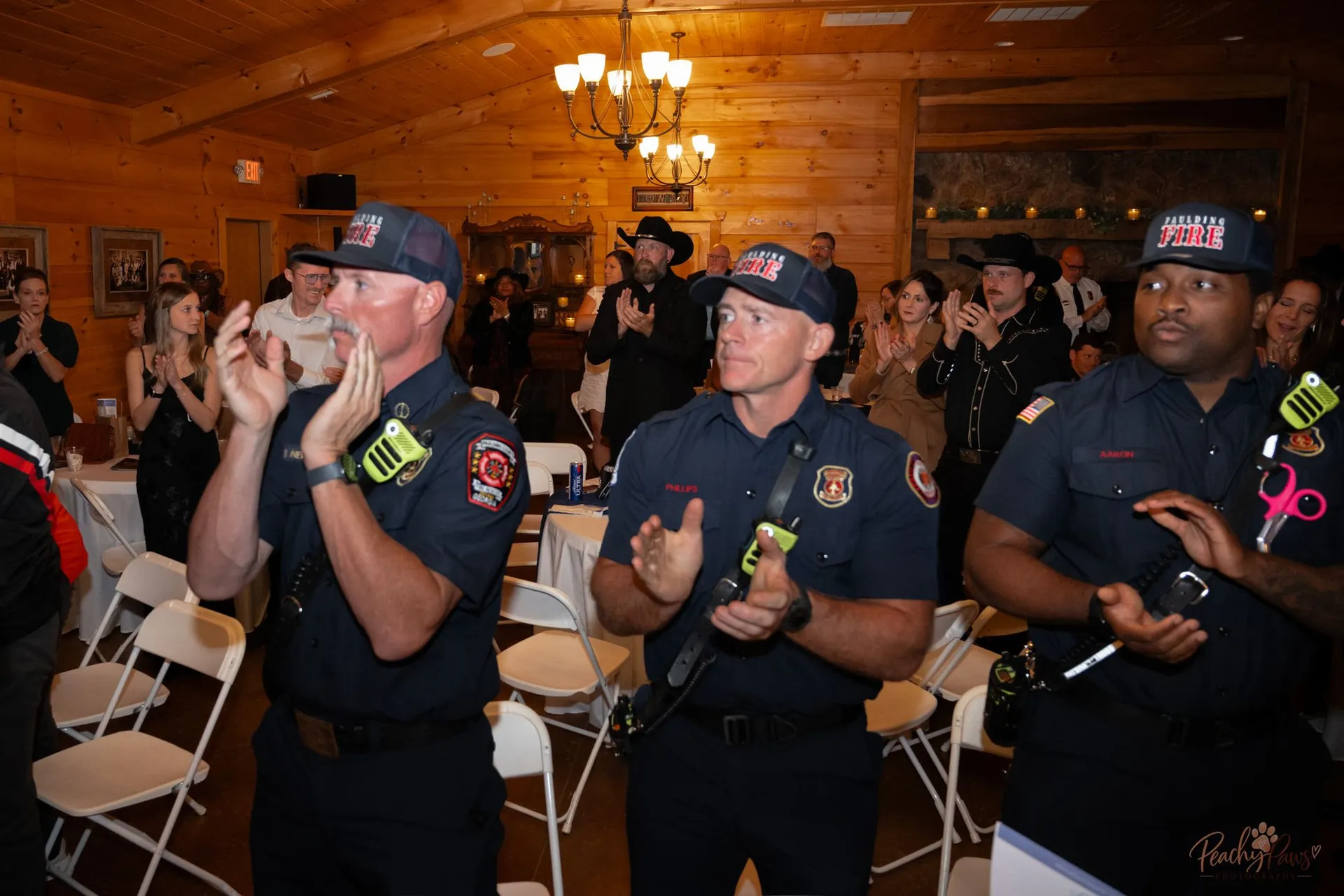 Paulding County firefighters applauding at the Blue Jean Ball