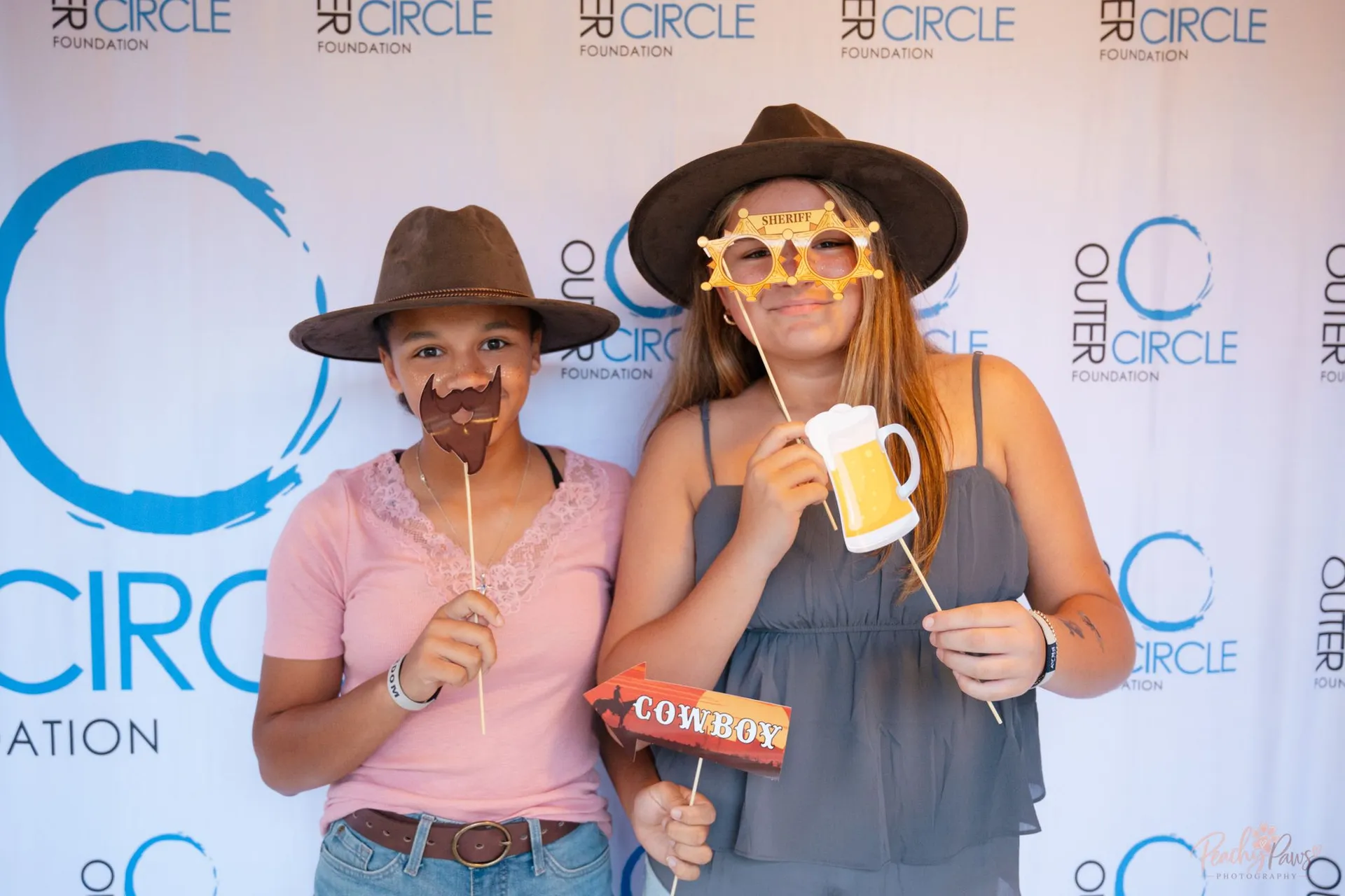 Guests enjoying the Western-themed photo booth at the gala