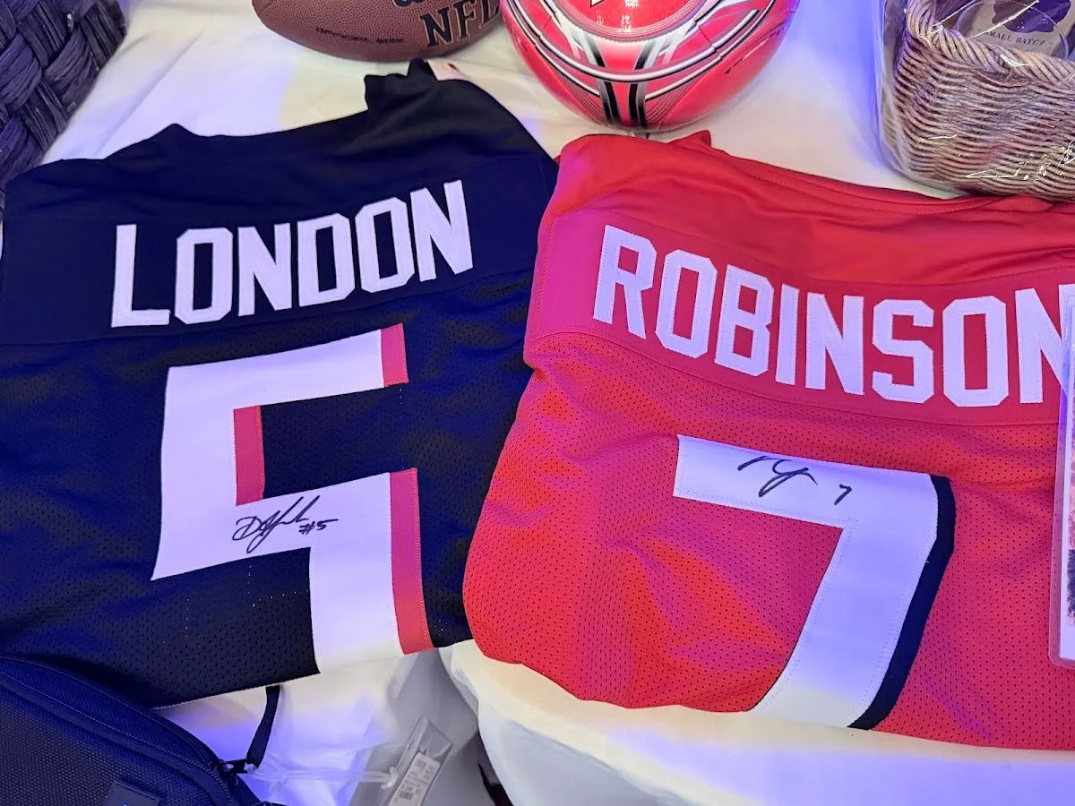 Signed football jerseys displayed among community-donated items at the Blue Jean Ball